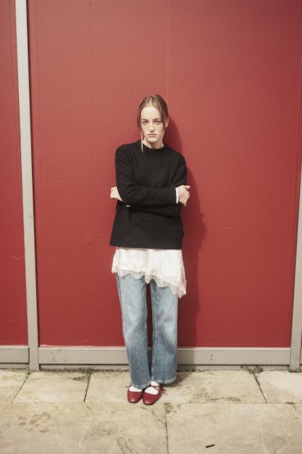 Person in casual wear leaning against a wall representing lifestyle integration