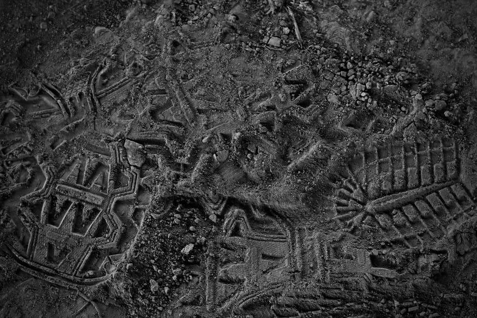 Textured ground with footprints representing the path of progress